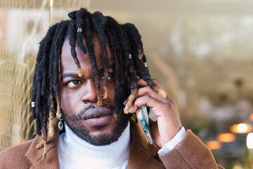Stressed African-American man talking by phone