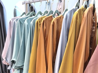 A collection of Muslim clothing for women with various designs, patterns and colors is sold in a clothing shop.