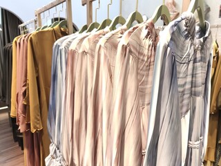 A collection of Muslim clothing for women with various designs, patterns and colors is sold in a clothing shop.