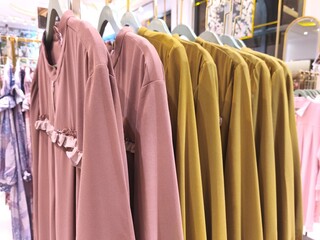 A collection of Muslim clothing for women with various designs, patterns and colors is sold in a clothing shop.