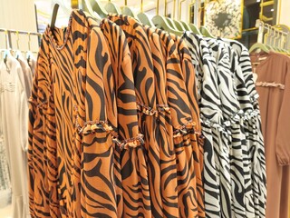 A collection of Muslim clothing for women with various designs, patterns and colors is sold in a clothing shop.