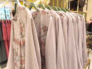 A collection of Muslim clothing for women with various designs, patterns and colors is sold in a clothing shop.