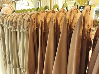 A collection of Muslim clothing for women with various designs, patterns and colors is sold in a clothing shop.