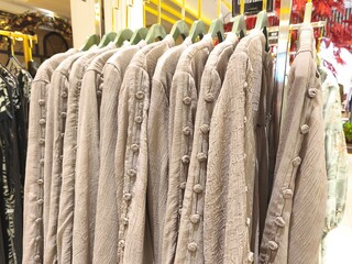 A collection of Muslim clothing for women with various designs, patterns and colors is sold in a clothing shop.