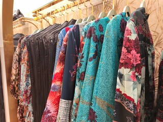 A collection of Muslim clothing for women with various designs, patterns and colors is sold in a clothing shop.