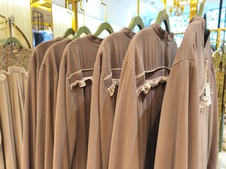 A collection of Muslim clothing for women with various designs, patterns and colors is sold in a clothing shop.