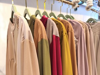 A collection of Muslim clothing for women with various designs, patterns and colors is sold in a clothing shop.