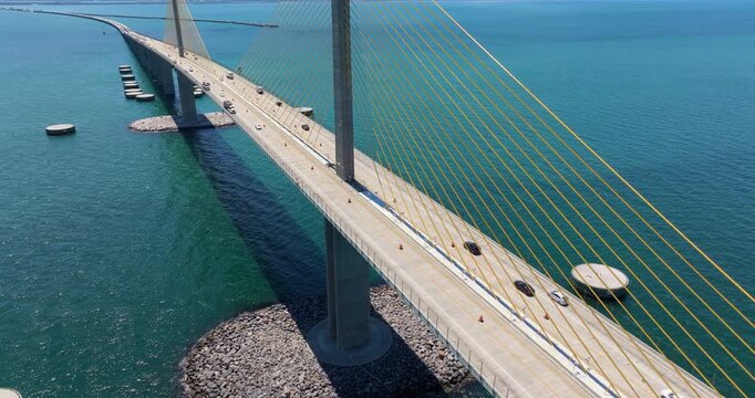Highway road with driving traffic cars on Sunshine Skyway Bridge over Tampa Bay in Florida. Transportation infrastructure in USA
