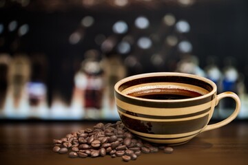 Coffee cup and beans on cafe background