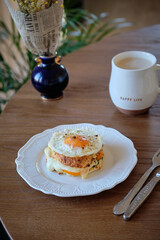 Cottage cheese round bagel sandwich. Healthy keto diet high-protein and vegetable breakfast or snack, with curd cheese bagels bread. Fried egg, yellow tomatoes, cheese