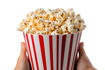 Freshly popped popcorn overflowing in a classic red and white striped container against transparent background