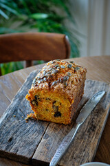 Pumpkin sweet bread with pumpkin seeds and walnuts. Wooden background, top view.