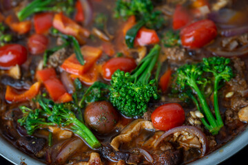 Close up of Healthy One Pot Meal of Ground Bison, Mushrooms, Broccoli, Barley, and Quinoa with Fresh Herbs
