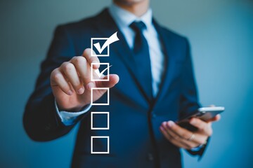 Businessman completing checklist on virtual screen for task management and productivity boost