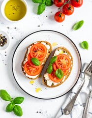 Top-down view of whole grain toast with ricotta, sliced tomatoes, olive oil, black pepper, basil garnish on white plate over marble. Bright, fresh, clean breakfast scene.
