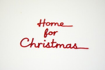 Red Thread Stitched Into Blank Paper Spelling Home For Christmas In Lowercase 1