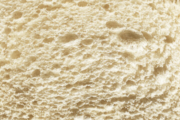 Bread texture closeup. Detail of bakery product surface. Fresh baked food pattern background. Wheat flour bread macro. Crumb texture concept with porous structure. Organic food background.
