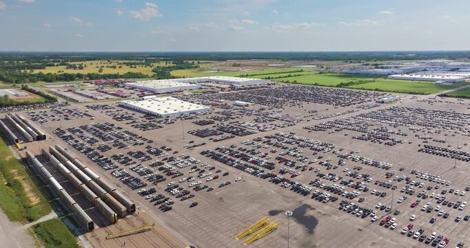 New cars parked on automotive factory parking lot for worldwide export. Dealer vehicle inventory business commercial.