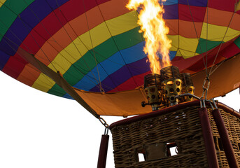 Obraz premium Macro close-up hot air balloon lower section: vibrant ripstop nylon, blazing brass burner, wicker basket, ropes, metal fittings on transparent background, powerful engineering study