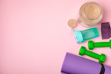 Protein shake with protein powder on a colored background. The powder is mixed with water or milk....