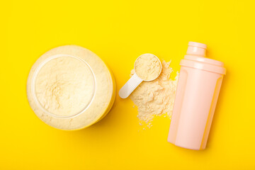 Protein shake with protein powder on a colored background. The powder is mixed with water or milk. A dietary supplement for a balanced diet. Whey protein. Fitness and gym diet nutrition.