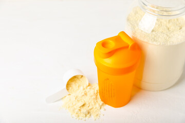 Protein shake with protein powder on a colored background. The powder is mixed with water or milk. A dietary supplement for a balanced diet. Whey protein. Fitness and gym diet nutrition.
