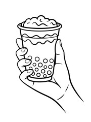 Hand holding a delicious bubble tea drink with tapioca pearls