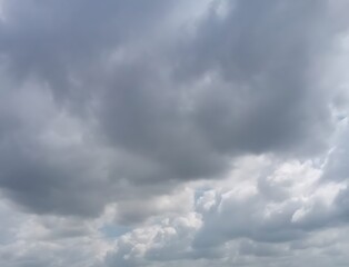 Dramatic cloudscape with heavy gray clouds and a hint of blue sky