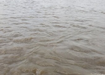 Serene Water Surface with Gentle Ripples and Neutral Tones Nature Scene