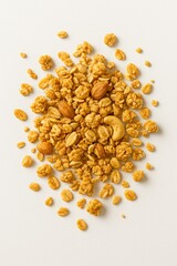 Granola cluster with almonds cashews and oats on a plain background Cereal