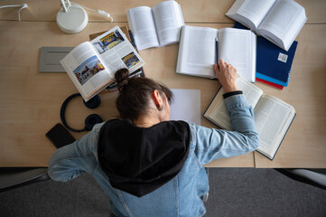 Tired student lying on desk in library