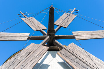 Rustic stone windmill with blue sky in the background