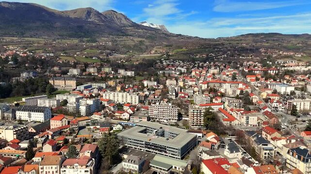 Cityscape of Gap in southern France captured from above showing residential district houses and surrounding mountain scenery