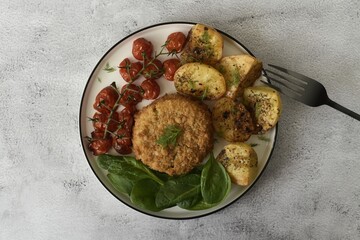 Baked cod fishcake with potatoes, victoria cherry vine tomatoes and fresh spinach.