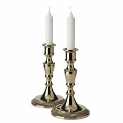 A pair of traditional brass candlesticks with white candles, isolated background.