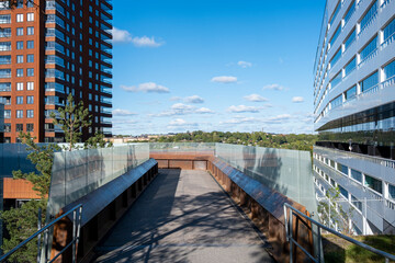 Perspective of apartment buildings and pedestrian walkway in Liljeholmen Stockholm, Scandinavian sustainable housing design highlighting clarity, rhythm, shadow, light and urban development