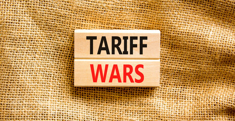 Trade tariff wars symbol. Concept word Tariff wars on beautiful wooden blocks. Beautiful canvas...
