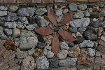 A close-up of traditional dry stone masonry. Dry stone masonry made from natural river rock, laid without mortar, in a classic Mediterranean style.
