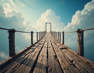 Naklejka premium A weathered wooden suspension bridge stretches toward a bright, cloudy sky, symbolizing journey and aspiration.