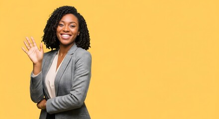A cheerful African American businesswoman, confidently smiling and waving on a vibrant yellow background, perfect for promoting positivity and professional communication.