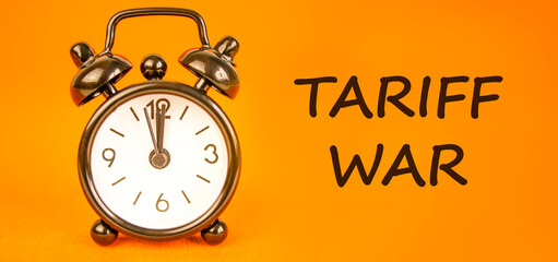 Trade tariff war symbol. Concept word Tariff war on beautiful orange paper. Beautiful black alarm...