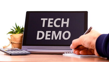 Tech demo symbol. Concept word Tech demo on beautiful black tablet. Businessman's hand with pen. Calculator. Beautiful white background. Business tech demo concept. Copy space.