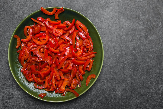 Grilled vegetables. Plate with grilled paprika stripes on dark background. Healthy food concept.