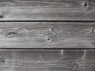 Weathered wooden background. Horizontal Thermowood planks in close-up.