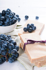 handmade soaps from red grapes seed oil, on white wood table