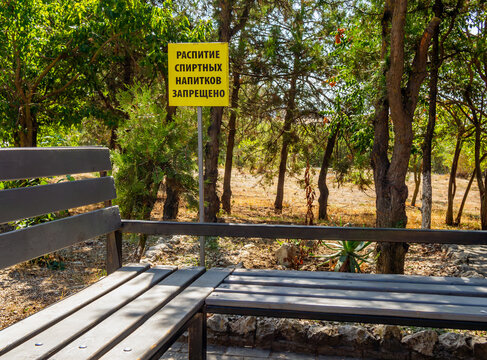 A sign near the benches. Translation caption: "Drinking alcoholic beverages is prohibited."