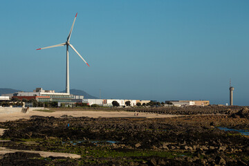 Wind turbine in Viana do Castelo near the beach at sunset, Portugal.