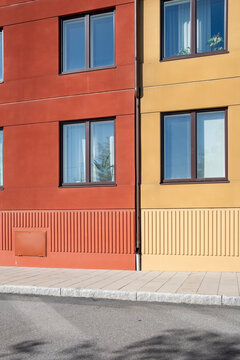 Colorful red and yellow fa&ccedil;ades in Stockholm urban apartments, Scandinavian modern housing offering vibrant yet minimalist background with copy space for templates, layouts and posters