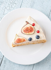 Slice cream cheese berry layer cake figs currant blueberries on plate