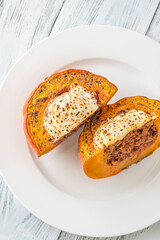 Portion of baked Hokkaido pumpkin with beef, tomato sauce, mozzarella cheese
